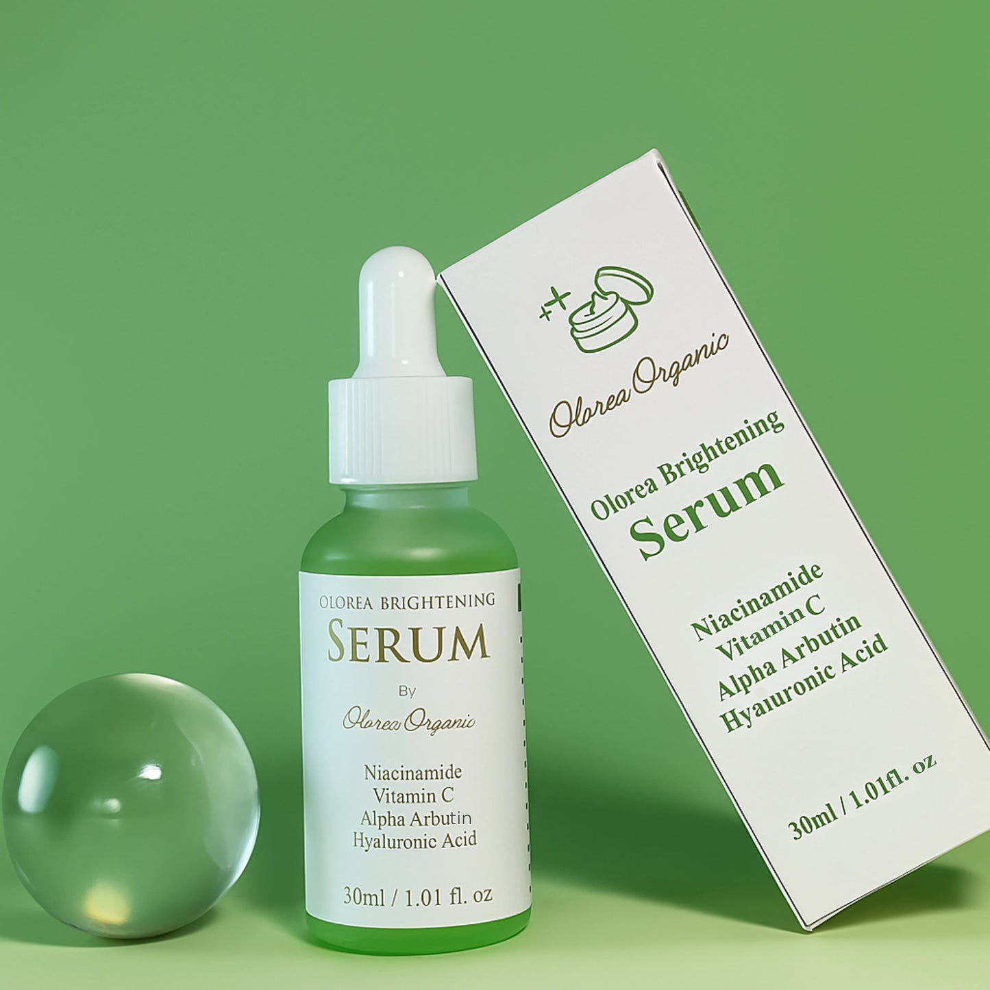 Olorea Organic Brightening Serum bottle and packaging on a green background